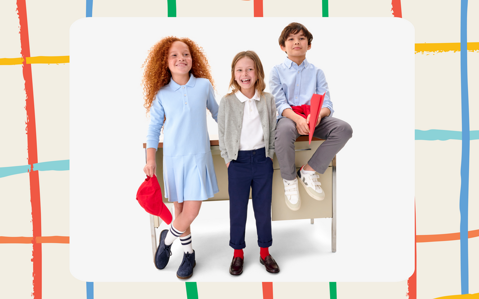 A group of children wearing school uniform basics including polos, chinos, cardigans, and polo dresses, all in neutral colors