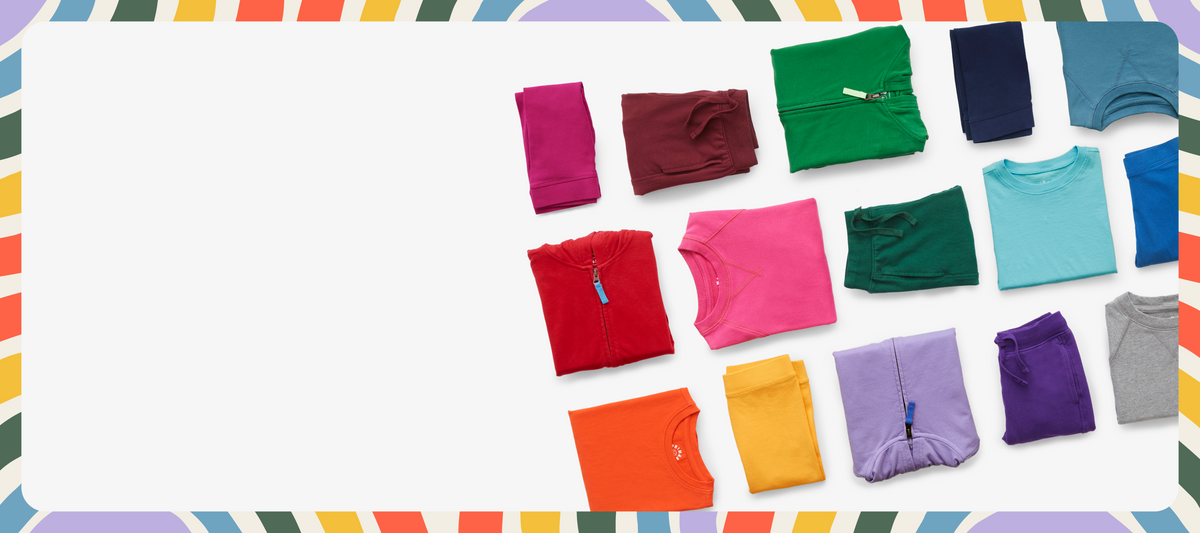 An image showing leggings, hoodies, joggers, tees, and more neatly folded in rainbow order.